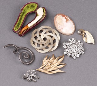 A shell carved cameo portrait brooch of Diana in a gilt mount, a Meerschaum cheroot holder in the form of a horses hoof, a swirl brooch marked WF, etc 