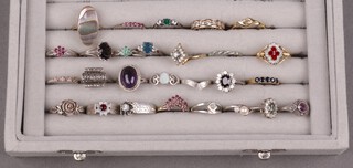 Twenty seven various silver and other dress rings, contained in a plush case 