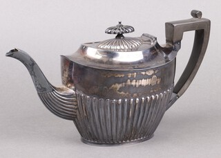 An Edwardian oval silver teapot with demi reeded decoration and ebonised handle Sheffield 1906 by Richard Richardson 556g gross