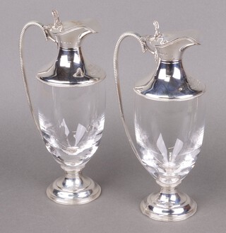 A pair of glass and silver mounted claret ewers, London 2007, both inscribed, 25cm h 