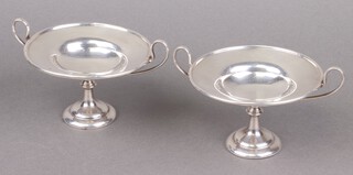 A pair of Edwardian silver twin handled dishes on spreading feet, London 1907 by Holland Aldwinckle and Slater, 240g 