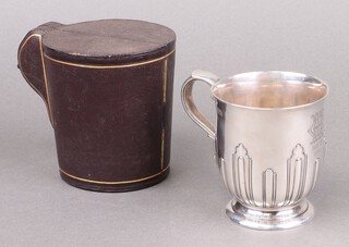 A Victorian silver christening tankard with demi-reeded decoration, inscribed, London 1892 by Carrington and Co., in original leather presentation case, 218g