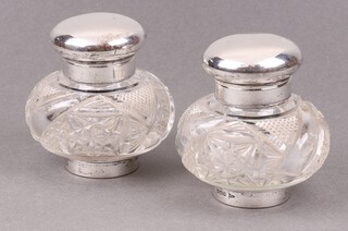 A pair of Edwardian cut glass and silver mounted inkwells, Sheffield 1905, 8cm h 