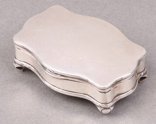 A shaped silver trinket box with hinged lid on panelled supports, Birmingham 1913, 69g