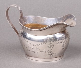 A Georgian style engraved oval silver cream jug, engraved, Chester 1913, marks rubbed 74g 