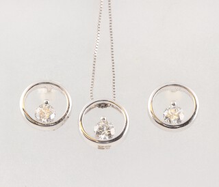A white gold marked 375 chain with diamond set pendant 0.085ct, together with a pair of matching diamond set earrings 0.170ct, both with GGI certificates, gross weight 1.8g 
