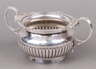 A Victorian circular silver twin handled sugar bowl with demi-reeded decoration London 1896 by William Hutton and Sons, 280g 