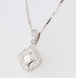 A white gold marked 18k diamond set pendant, the centre stone 0.19ct surrounded by diamonds 0.15ct, hung on a white gold marked 18k chain, with Northern Star Canadian diamonds certificate, gross weight 3.4g