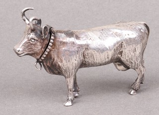 A marked 930 box in the form of a standing cow 5cm h x 8cm w 