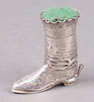 A Dutch silver pin cushion in the form of a riding boot with spur, import mark London 1900, gross weight including padding 34g 
