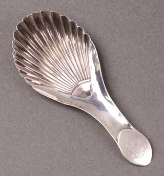 A Georgian silver scallop shaped caddy spoon, monogrammed B, Birmingham 1806 by John Heart and Co.,