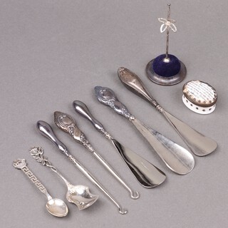 Three silver handled shoe horns, 2 silver handled button hooks etc 