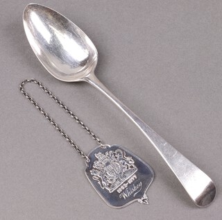 A Georgian silver Old English pattern table spoon London 1829 by Robert Essex, together with a 1977 Queens Silver Jubilee limited edition Whisky decanter label 1156/2500 with Jubilee hallmark, 92g 