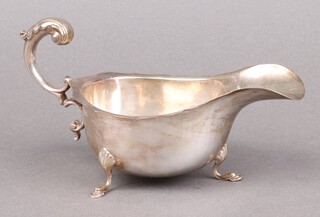 A silver sauce boat with C scroll handle and wavy border, Chester 1931, 131g 