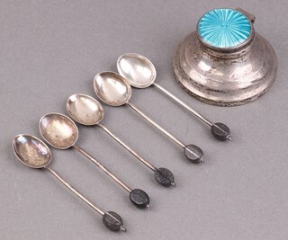 6 silver bean end coffee spoons Birmingham 1924, 35g gross, together with a silver capstan inkwell with enamelled lid Birmingham 1946 6cm (hinge damaged and dented throughout)