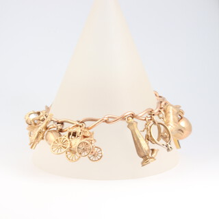A 9ct gold single Albert watch chain, converted to a charm bracelet, hung 17 various charms, 24cm, gross weight 51.3g 