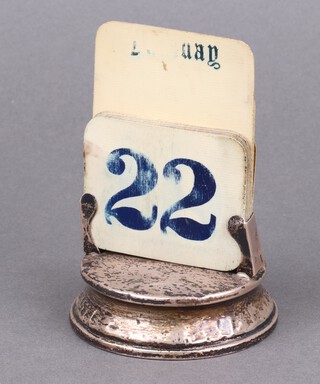 A silver perpetual calendar on a circular base London 1926, 7cm 