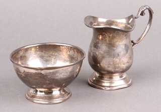 A silver baluster shaped cream jug Sheffield 1937 (base misshapen) together with a silver sugar bowl Sheffield 1939 (dented), 206g