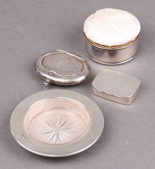 An oval silver powder compact Birmingham 1918, marks rubbed (some dents), a circular silver butter dish with glass liner Chester 1913 8cm, a silver box Birmingham 1909, together with a white metal pill box with hinged lid 4cm 