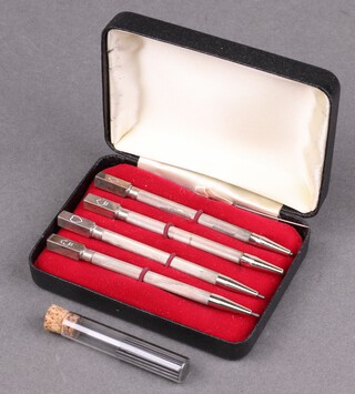 Four Sterling silver bridge pencils with engined turned decoration, 25g including leads 