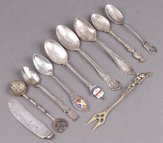 A silver fruit knife blade, a silver and enamelled souvenir spoon and a quantity of Continental souvenir spoons