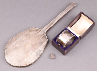 A silver backed hand mirror, Birmingham 1936, a Victorian silver napkin ring, inscribed, Sheffield 1899 and a silver ARP lapel badge, weighable silver 42g