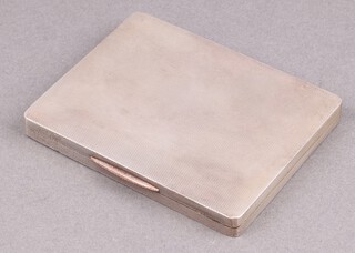 A rectangular silver cigarette case/pill box with parcel gilt interior and hinged lid, Birmingham 1944 by W H Manton Ltd.