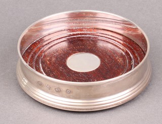 A circular silver and mahogany bottle coaster Birmingham 1988 by W I Broadway & Company 12cm 