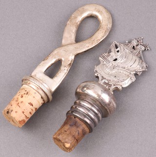 A Continental 925 silver bottle stopper in the form of a galleon together with 1 other 