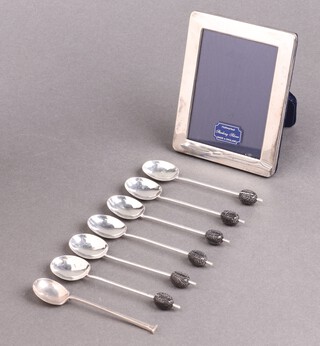A silver easel photograph frame 10cm x 8cm London 1997, 6 silver bean end coffee spoons Birmingham 1932 and a silver coffee spoon
