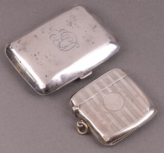 A silver vesta case with engine turned decoration Birmingham 1911  and a silver cigarette case monogramed Birmingham 1929, 83g