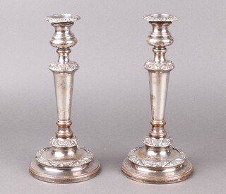 A pair of silver plated candlesticks with cast decoration 28cm (wear in places)