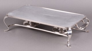 A rectangular silver plated twin handled hot plate, raised on cabriole supports complete with burners 10cm h x 46cm w x 24cm d (finial to 1 handle missing)