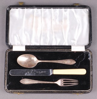 A silver christening set with spoon and fork Birmingham 1958, 44g (prongs to fork are bent), cased, together with a knife  