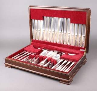 An Elkington 94 piece canteen of Chippendale pattern silver plated flatware comprising 9 fish knives, 8 forks, 9 table knives, 9 tea knives, 4 serving spoons, 9 soup spoons, 9 table forks, 9 dessert spoons, 9 dessert forks 9 tea spoons, 9 coffee spoons, carving knife and fork, all contained in a figured walnut canteen box 