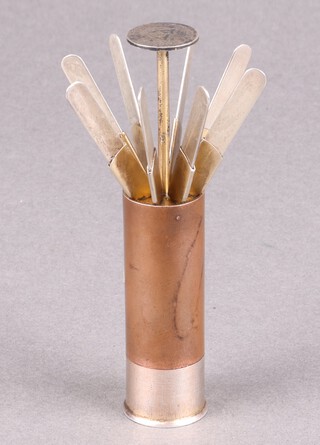 Asprey, a Sterling silver and copper shotgun place/butt marker in the form of a shot gun cartridge, the twist action opens to reveal eight hand engraved numbered pegs for a driven shoot, the base marked "Asprey's Cartridge Place Finder"  6cm 
