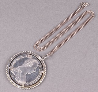 A Marie Therese silver crown mounted as a pendant hung on a metal chain 