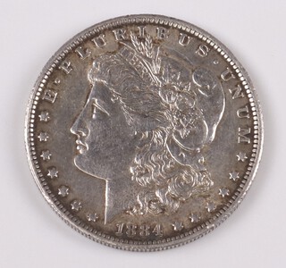 An American silver Morgan dollar dated 1884 New Orleans Mint 