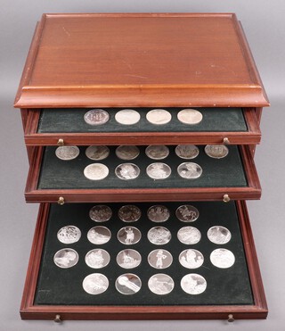 John Pinches "The 100 Greatest Masterpieces", a complete set of 100 silver medallions in a fitted mahogany coin chest of 6 drawers with brass handles, complete with certificates of authenticity, each medallion approx 65g