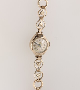 A lady's Talis Swiss wristwatch with silvered dial, Arabic numerals, the movement marked 21 jewels Swiss, contained in a 9ct gold case with integral rolled gold bracelet 