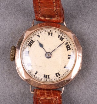 A lady's 15 jewel wristwatch with white dial, Roman numerals contained in a 9ct gold case with leather strap 