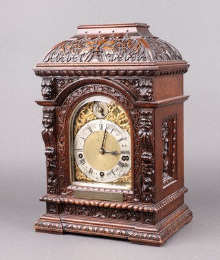 A Victorian Winterhalder & Hofmeire 8 day striking bracket clock with 16cm gilt dial, silvered chapter ring and Roman numerals, striking on 5 gongs, contained in a heavily carved oak case, with presentation plaque "Presented to Mr Frank Clocks by the officials and employees of The London Scottish Western Railway, Western District, upon his appointment as Permanent Ways Super Intendant at Wimbledon Exeter December 1900", complete with pendulum and key 43cm h x 28cm w x 20cm d 