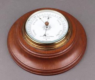 Negretti and Zander, an aneroid barometer with enamelled dial marked R/11749, contained in an oak case 22cm 