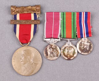 A group of 3 miniature medals comprising British Empire medal Military issue, Defence and War medal, mounted for wear together with an LCC School Attendance medal to I Favell 