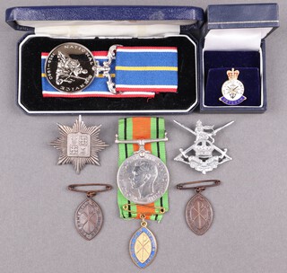 A National Service medal boxed, a Defence medal, a Junior Leaders Regiment cap badge, a London Regiment cap badge and 3 Army Guild of St Helena medals