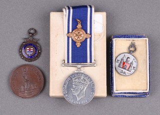 A George VI issue Police Long Service Good Conduct medal to Constable Robert A Watson Metropolitan Police in original box of issue, a St John Ambulance Association medal and 3 sports medals 