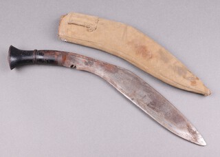 A Kukri with 32cm blade, wooden grip and canvas scabbard 