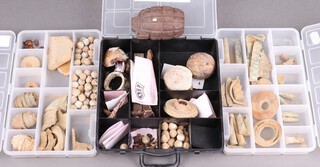 A collection of recovered First World War shell bullet cases, shrapnel etc, a mills bomb, contained in 3 shallow boxes