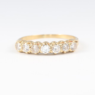 A gold testing as 22ct 7 stone diamond set ring, size N 1/2, 2.1g