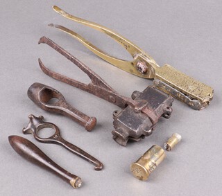 An 18th Century metal tongue bullet mould with inscription to arm, a brass and lead grape shot mould, 2 wadding punches and a measure 